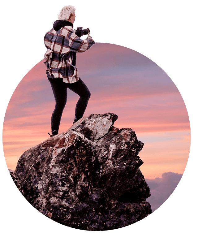 Woman taking photograph on a rock
